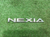 Эмблема-надпись Nexia 2*17см пластик б/у (арт. 96211220)